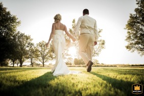 In Philadelphia, the newly married couple walks calmly hand in hand into the soft morning light, embraced by the peaceful stillness immediately following their vows.
